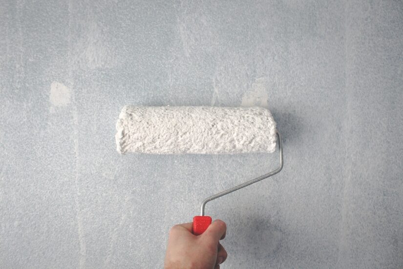Painting a wall with a paint roller