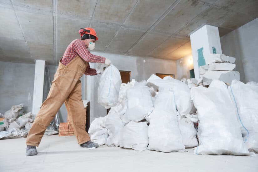 Photo of a Man Collecting Construction Waste